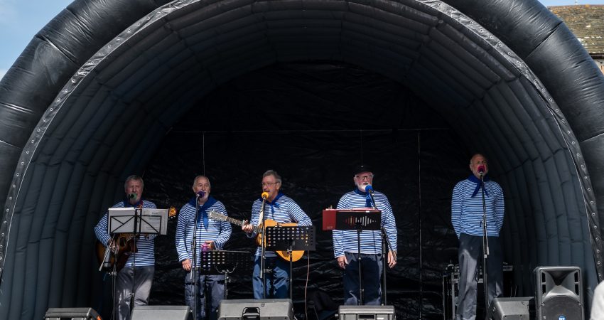 A photo of some musicians at the taste of the sea festival.