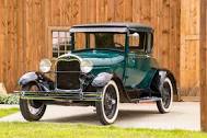 A photograph of a vintage car painted green.