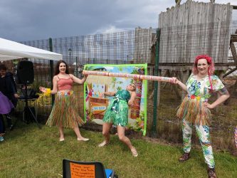An image of three people doing some limbo dancing from the royal-family-fun day