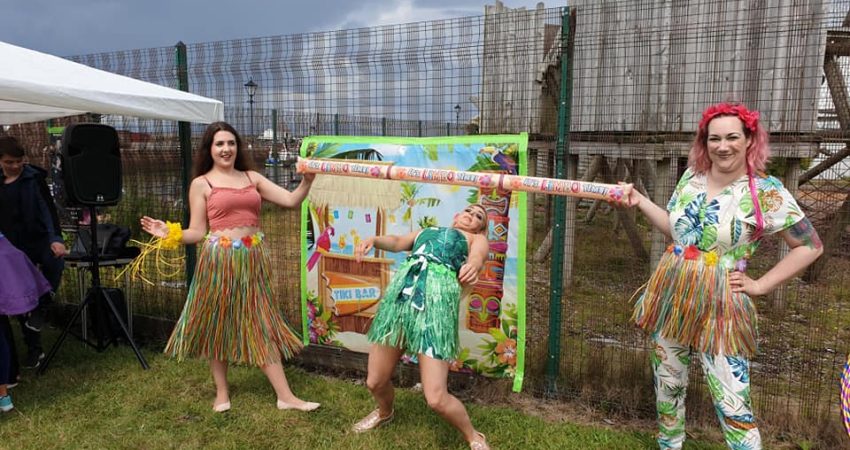 An image of three people doing some limbo dancing from the royal-family-fun day